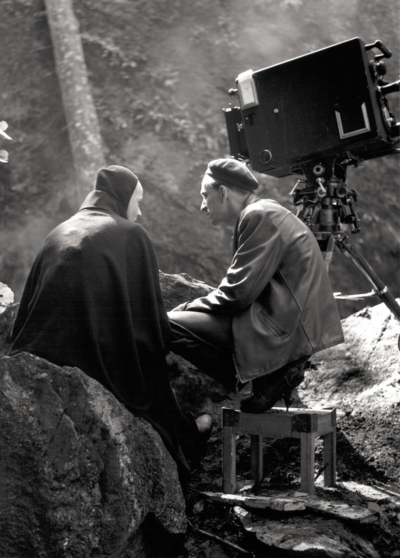 Hinter den Kulissen: Drehmomente - Ingmar Bergman lauscht andächtig oder ein wenig gelangweilt den Ausführungen Max von Sydows, der in Das siebente Siegel mit dem Teufel höchstselbst zusammentreffen wird.